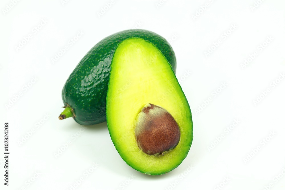 Avocado fruit and one half with seed, on white background.