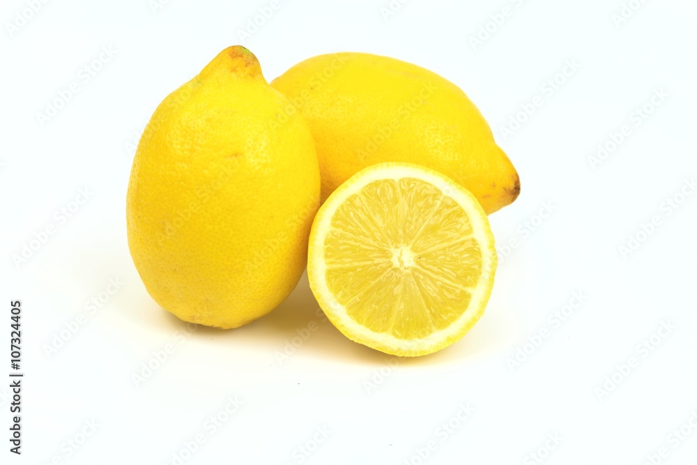 Two lemons and one half, on white background. Two lemons and one half, on white background.
