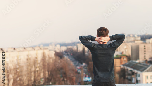 teenager is looking off into the distance while standing on the