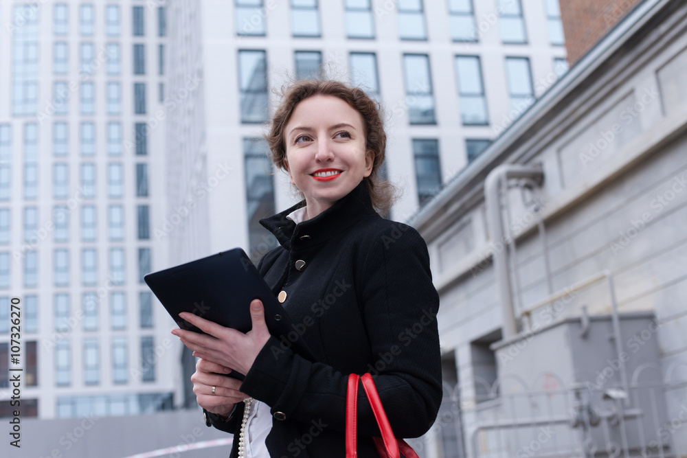 business woman with tablet in hands against urban city background business woman with tablet in hands against urban city background