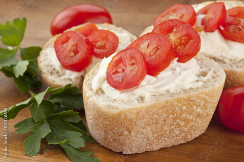 closeup buttered bread with tomatoes