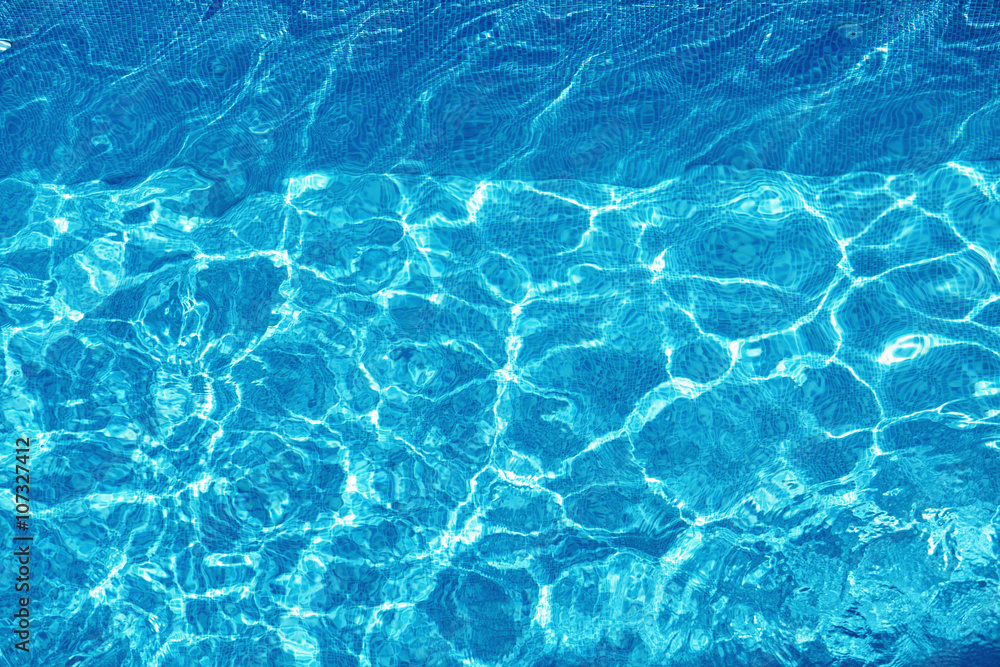 Water Background. Shining Blue Ripped Water Surface In Hotel Swimming Pool With Bright Sunny, Sun Light Reflections. Liquid Texture. Summertime. Summer Holidays Vacation Concept. Water Background. Shining Blue Ripped Water Surface In Hotel Swimming Pool With Bright Sunny, Sun Light Reflections. Liquid Texture. Summertime. Summer Holidays Vacation Concept.