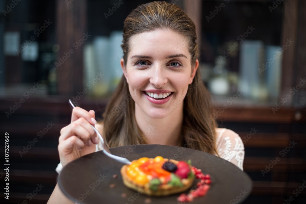 Portrait of happy woman with tart 