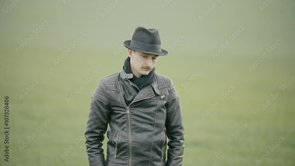 A man in a leather jacket and hat A man in a leather jacket and hat