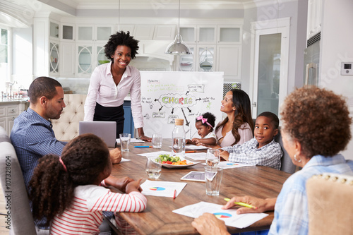 Businesswoman presents meeting to a family in their kitchen