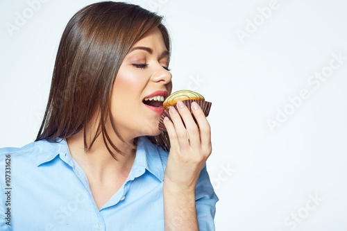 Young woman biting french cookie. Close up face portrait