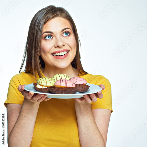 Close up face portrait of happy woman holding plate with macaro photo