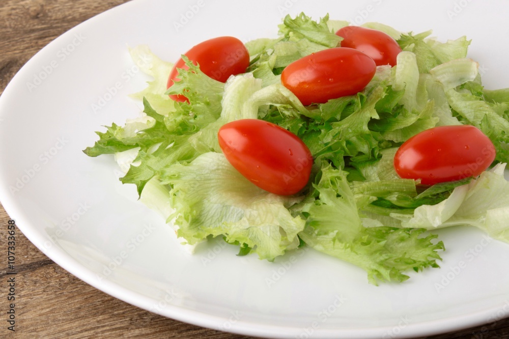 Fresh salad on a wooden background Fresh salad on a wooden background