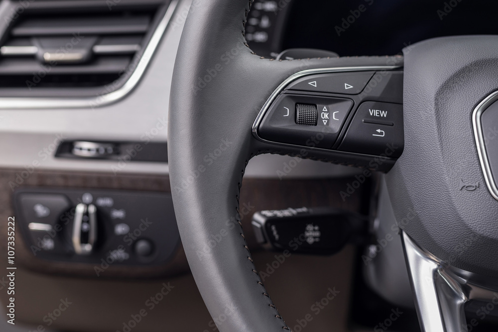 Buttons on steering wheel. Car interior detail.