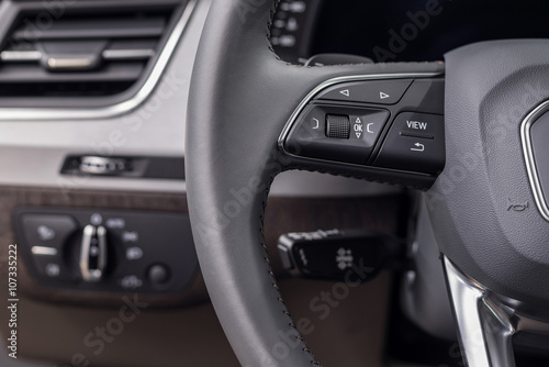 Buttons on steering wheel. Car interior detail.