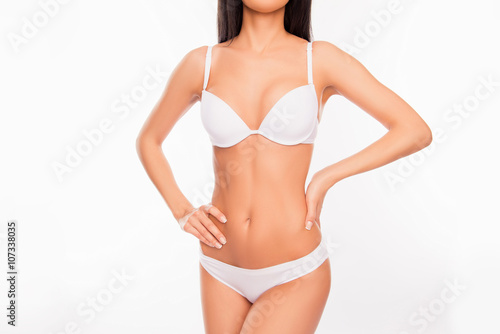 Sey slim woman posing in underwear on white background, close up