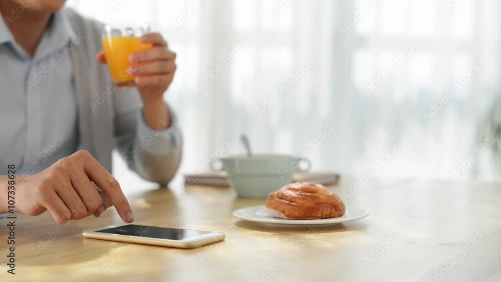Cinemagraph of man using smartphone when having breakfast Cinemagraph of man using smartphone when having breakfast