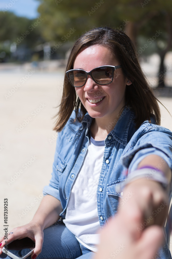 Portrait of black-haired woman in sunglasses