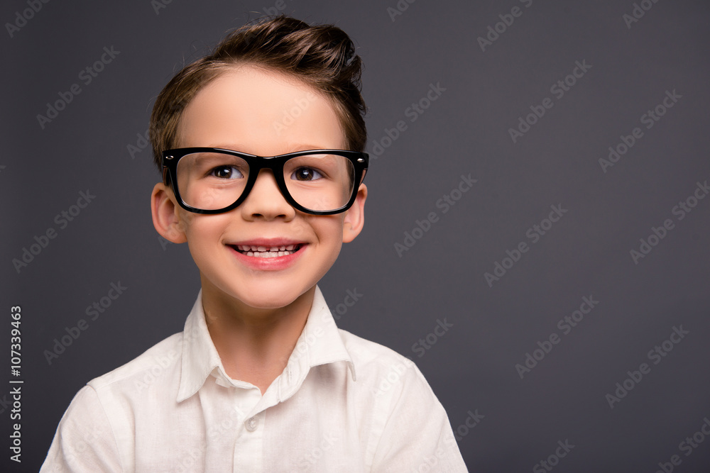 Portrait of handsome smiling little smart schoolboy in glasses Portrait of handsome smiling little smart schoolboy in glasses