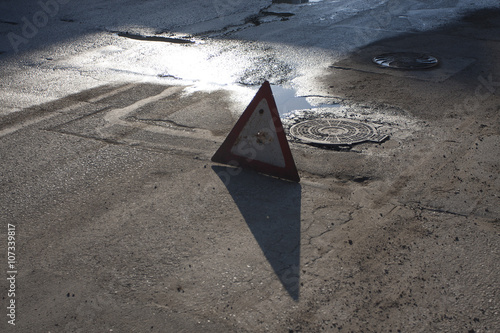 Road with hatches and a warning sign photo