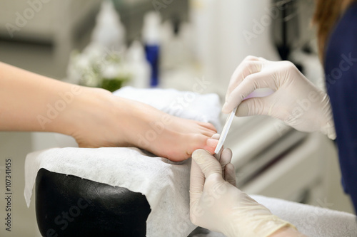 Master pedicure doing qualitative service. professional approach to the service sector.