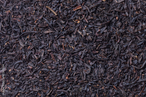 Dry black tea leaves as texture for background