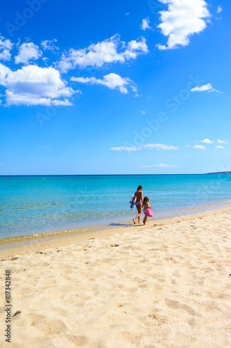 two sisters walking on the beach, tropical sea background