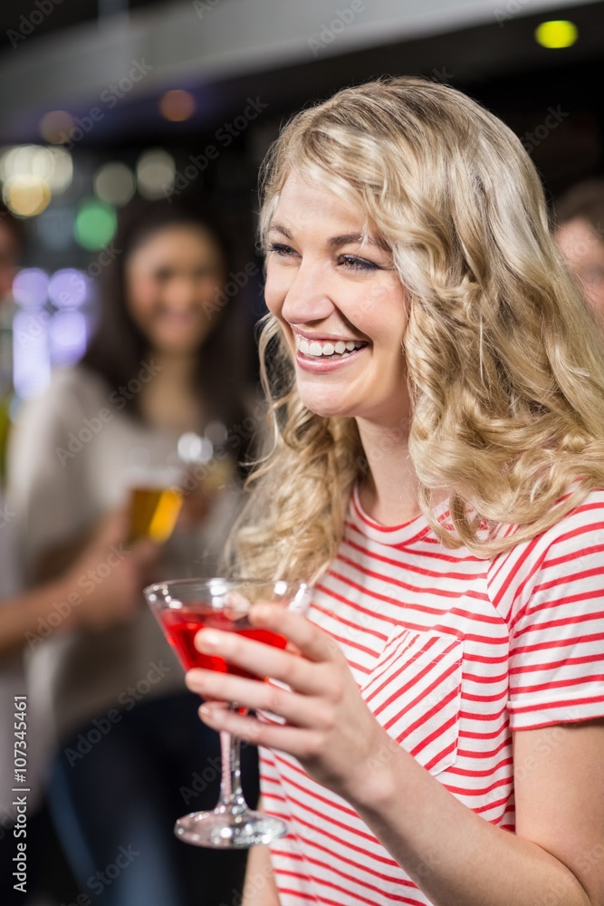 Blonde woman having cocktail with her friends Blonde woman having cocktail with her friends