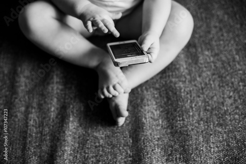 Portrait of cute little girl with the phone