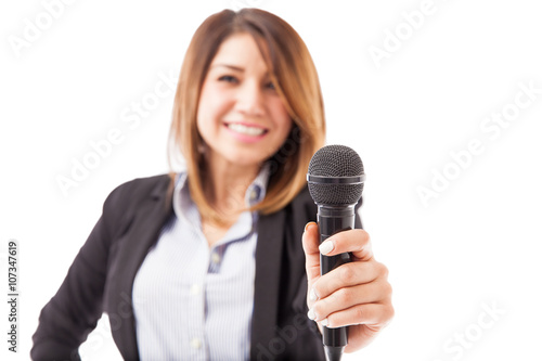 Female presenter handing over the microphone