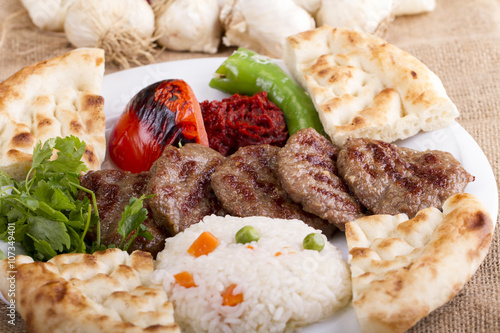 Delicious Turkish Traditional Kebab Kofte with pilaf on white plate (meatballs)