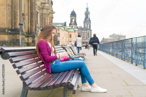 Canvas Print Woman tourist writes his impressions in a diary, Dresden, German