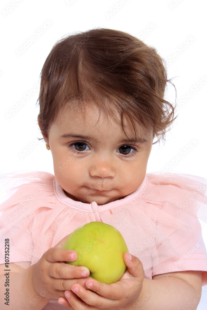 Child eating green apple. Studio Half Length Portrait , isolated on a white background Child eating green apple. Studio Half Length Portrait , isolated on a white background