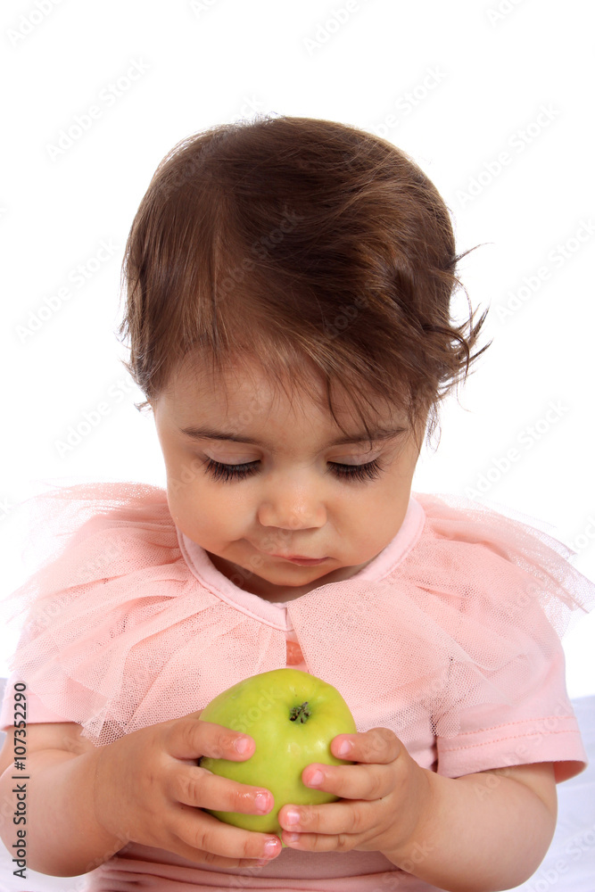 Child eating green apple. Studio Half Length Portrait , isolated on a white background Child eating green apple. Studio Half Length Portrait , isolated on a white background