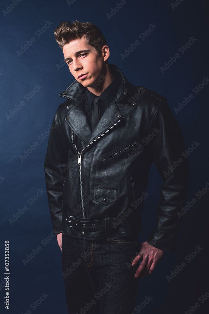 Cool vintage rock and roll 50s fashion man wearing black leather