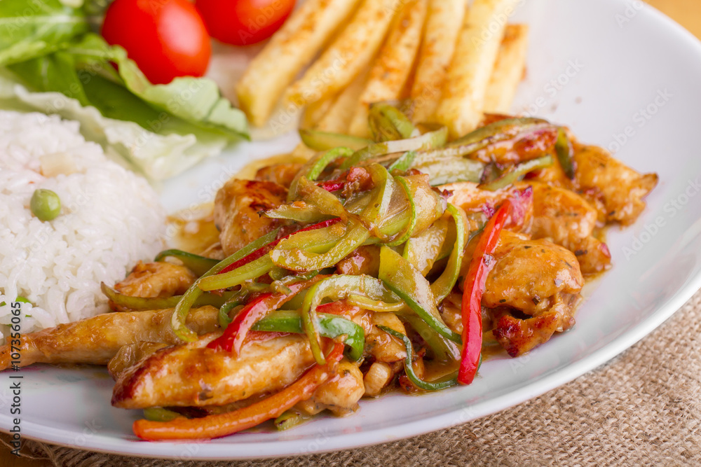 original fajita sizzling smoking Chicken breast with vegetables and sauce decorated with basil leaves original fajita sizzling smoking Chicken breast with vegetables and sauce decorated with basil leaves