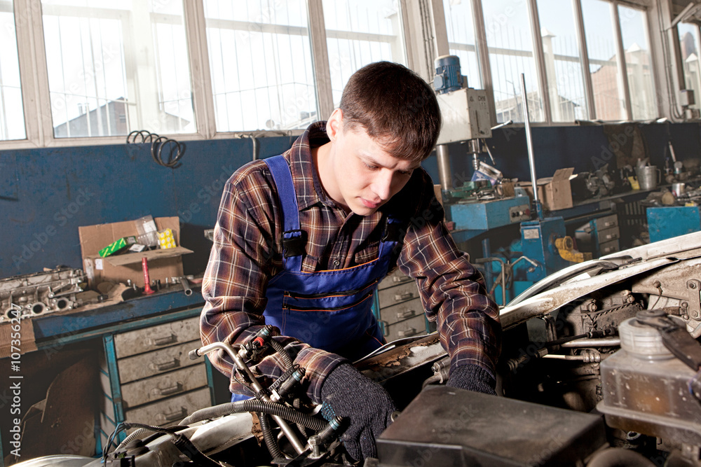 Car mechanic working in auto repair service Car mechanic working in auto repair service