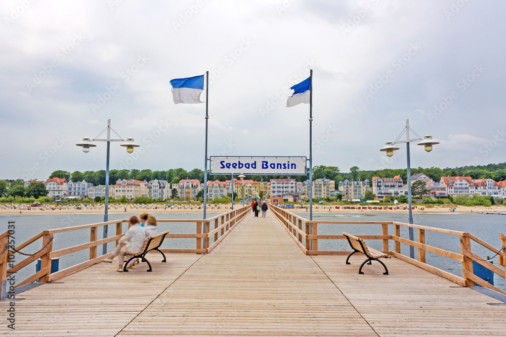 Bansin, Usedom, Germany - June 27, 2012: Pier of the baltic sea spa town Bansin - a famous tourist hotspot. Pier sign labeled with sea spa town Bansin (Seebad Bansin). - obrazy, fototapety, plakaty 