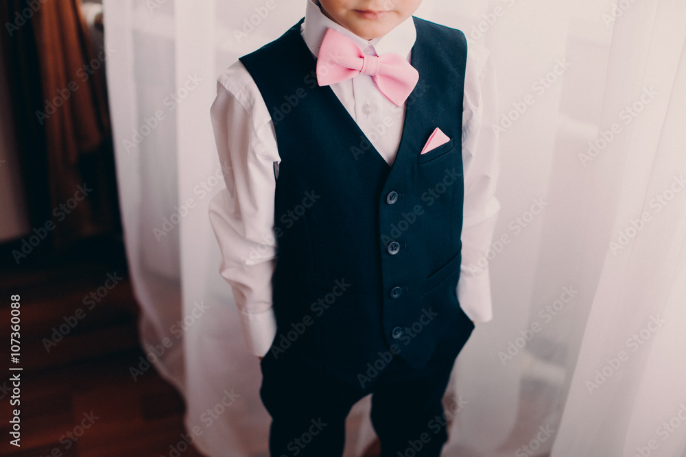young wedding boy in pink bow tie and black vest Stock Photo | Adobe Stock