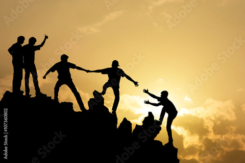 Group of people on peak mountain  climbing helping team work , s photo