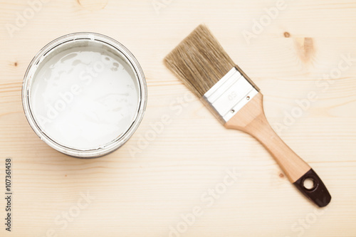 Paint and brush on the Pine wooden background with copy space