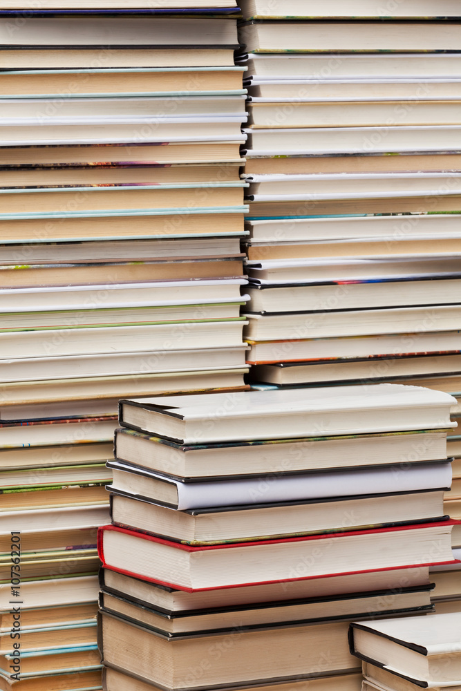 books are stacked against a wall books are stacked against a wall