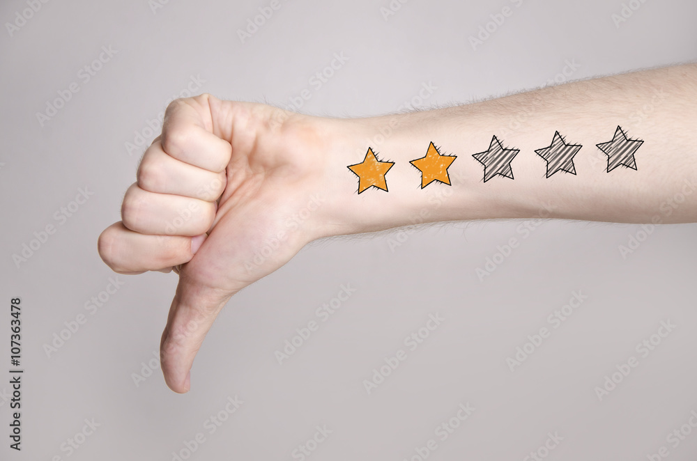 Mans hand showing thumb down and two star rating tattoo like drawing Stock  Photo | Adobe Stock
