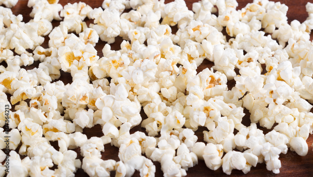 Closeup pile of white fluffy popcorn lying mixed together Closeup pile of white fluffy popcorn lying mixed together