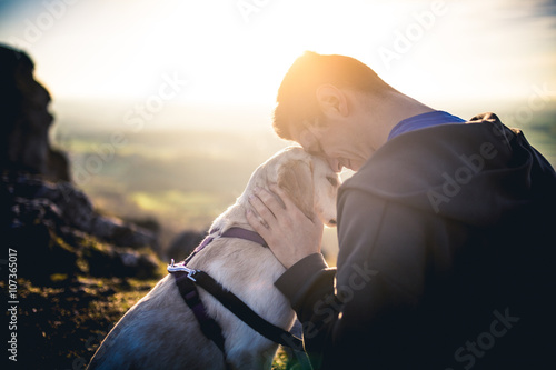 Dog and man in landscape photo