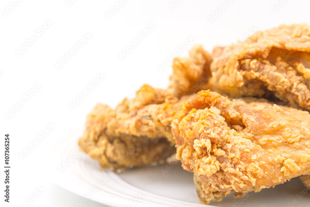Fried chicken in white plate on white table, on isolate Fried chicken in white plate on white table, on isolate