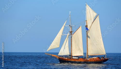 Принти на полотні old historical tall ship (yacht) with white sails in blue sea
