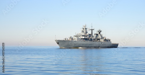 Fototapeta Grey modern warship sailing in still water