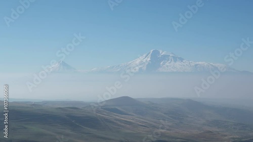 Snow-capped Ararat mountain and blue sky with smog photo