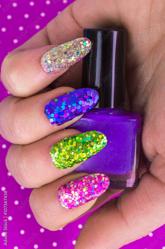 Fashionable Stylish Colorful nails and nail polish on a bright background. Manicure nail painting. Beauty hands. Fashionable Stylish Colorful nails and nail polish on a bright background. Manicure nail painting. Beauty hands.