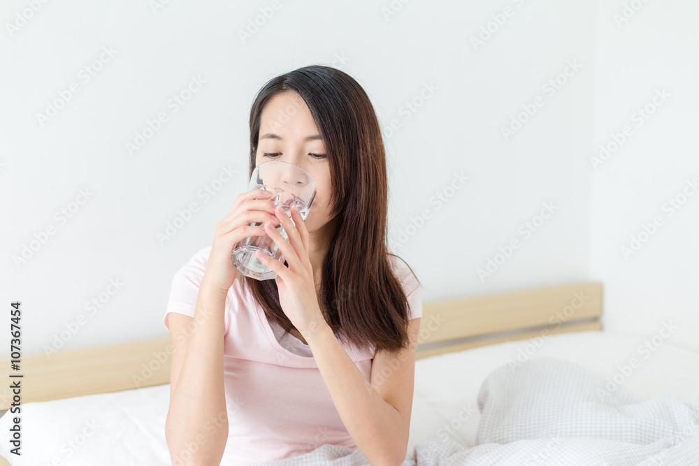 Woman taking a glass of water Woman taking a glass of water