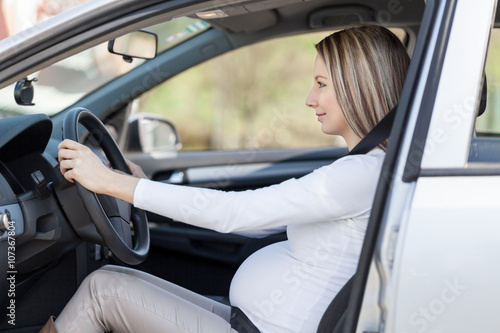 Pregnant woman driving her car © and.one