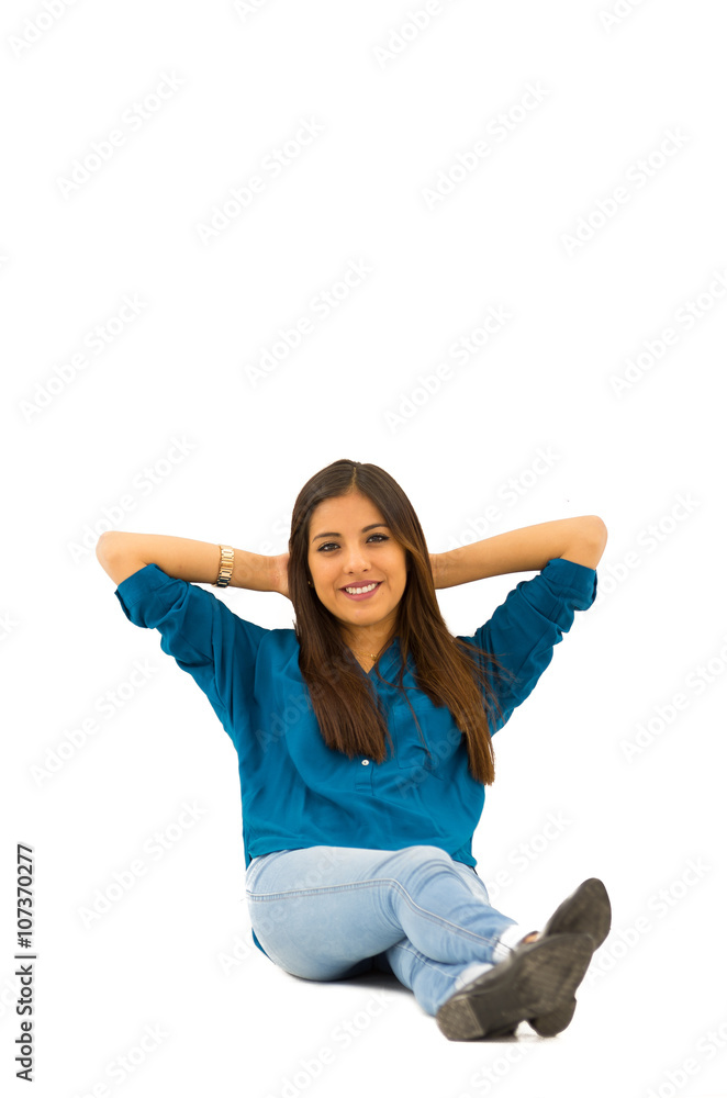 Brunette model wearing casual clothes sitting comfortable on white background smiling to camera Brunette model wearing casual clothes sitting comfortable on white background smiling to camera