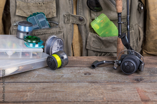 fishing tackles with fishing vest and wooden