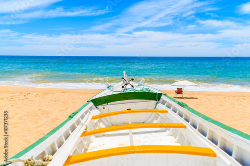 Colorful typical fishing boat on beach in Armacao de Pera coastal village, Portugal © pkazmierczak